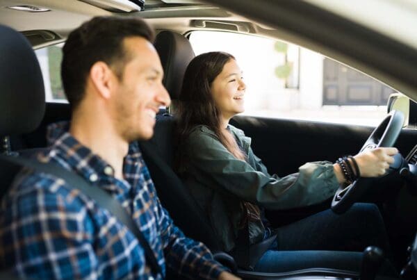 Happy and Smiling Dad With His Teenage Girl Practice Safe Driving Together in Preparation for Her Drivers License Test